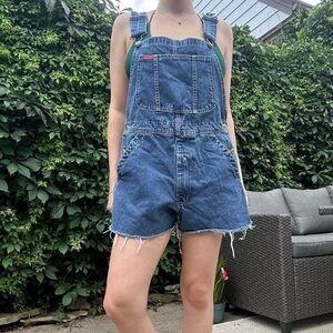 Vintage 90s blue denim overall shorts with distressed frayed hem